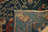 Hand-knotted antique Seichor Kuba rug: dark navy geometric pile and woven blue foundation.