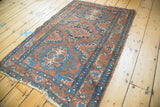 Intricate brick red and sky blue Heriz rug border, highlighting detailed pattern and light side tatter.