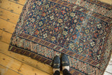 Late 19th-century Caucasian rug with intricate geometric lattice on navy, showing its even wear.