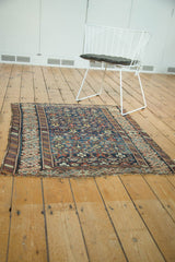 Hand-knotted antique Caucasian rug featuring intricate geometric motifs and time-softened colors.