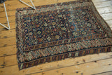 Intricate geometric border and field motifs of an antique Caucasian rug, showing even wear.