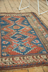 Unique geometric patterns, madder root red, sky blue, and even wear on vintage Caucasian rug.