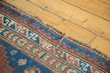 Vintage Caucasian rug end shows geometric madder red, sky blue pattern and plain weave tatter.