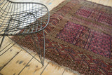 Worn pile and tattered fringe of an antique Turkmen rug's edge.