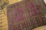 Antique Turkmen rug showing corner with storied wear, raspberry field, and crab style border.