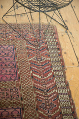 Hand knotted antique Turkmen rug showcasing geometric crab style border and edge tatter.