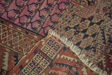 Antique Turkmen rug corner revealing madder red, navy, ivory geometric patterns and hand-knotted weave.
