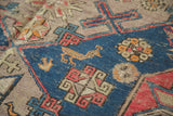 Textural detail of antique Caucasian Soumac, showcasing a navy blue field with a stylized animal motif.