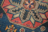Antique Caucasian Soumac detail: geometric octagonal and diamond motifs in blue, red, beige.