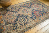Antique Caucasian Soumac carpet's distinctive wave design outer border and tattered fringes.