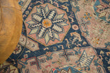 Geometric octagonal medallion in navy, blush, ivory on Antique Caucasian Soumac, with foundation wear.
