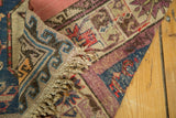 Tattered fringe and vibrant geometric border patterns of an antique Soumac rug.