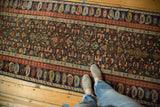 Detail of antique geometric Caucasian Kuba runner: lattice field and repeating boteh border.