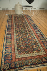 Antique Caucasian rug's detailed geometric lattice and repeating panel motifs, with rich boteh border.
