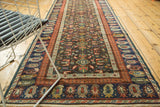 Antique Kuba Caucasian runner detail: repeating boteh border in madder root red and navy blue.