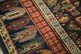 Hand-knotted detail of antique Caucasian runner: lattice panels, boteh, and geometric borders in navy, madder root red, ivory.