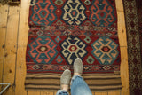 Shahsavan Kilim rug detail: stylized medallion in navy and beige with intricate embroidered band.