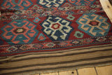 Vintage Shahsavan kilim detail: teal crab medallion, intricate geometric embroidery, striped flatweave, tattered fringe.