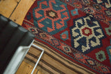 Intricate embroidered band and geometric crab medallion on vintage Shahsavan kilim rug.