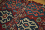 Intricate horizontal embroidery and geometric crab motifs on a vintage Shahsavan Kilim rug.
