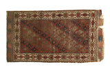 Antique hand-knotted Belouch rug: chestnut brown field with diagonal medallions and starburst border.