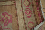 Bubblegum pink floral motifs, chocolate brown accents, and abrashed camel Oushak rug.