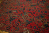 Vintage Beshir rug's cherry red field, navy gul patterns, and visible knot head wear.