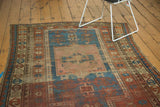 Antique Kazak rug's square medallion and starburst prayer niche, featuring madder red and sky blue.