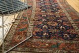 Kurdish runner with deep navy Mina Khani pattern, terra cotta border, and time-softened antique texture.