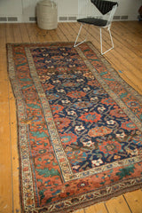 Antique Kurdish rug corner detail with ornate Mina Khani pattern and visible edge wear.