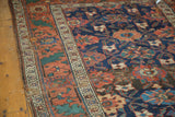 Angled view of antique hand-knotted Kurdish Persian Mina Khani pattern in navy and terra cotta.