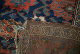 Close-up of antique Kurdish runner with hard tatter, showing woven back and seamed join.