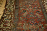 Antique Kurdish Bijar rug edge: heavy tatter, beige border, madder red Herati motif.