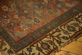 Antique Kurdish Bijar rug corner with unique Herati motif, madder red field, beige border, and tattered fringe.