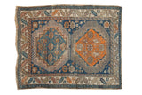Antique Caucasian rug with double hexagonal medallions, time-softened navy, tangerine, and sky blue tones.