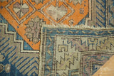Exposed hand-knotted weave and tattered edge of antique Caucasian rug, geometric patterns.