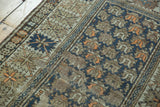 Antique Caucasian rug with geometric serrated border, staggered floral motifs, and even wear.