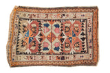 Antique Caucasian rug featuring rectilinear serrated motifs in tangerine, navy, ivory, and blush, 2'9