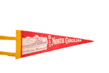 Vintage USS North Carolina felt pennant with battleship graphic and text, flat overhead view.