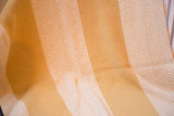 Mustard yellow blanket showing textured weave and crisp white herringbone stripe pattern.
