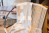 Gray and white Swiss cross blanket, soft fabric texture.