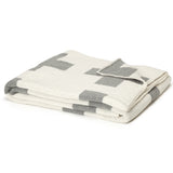 Folded gray and white knitted blanket with a Swiss cross pattern, 50x60 inches.