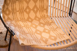 Southwestern design blanket with bold geometric motif in beige and tan.