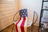 American Flag Throw with blue field of white stars and red and white stripes.