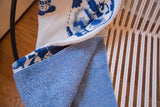 Delft blue Eco-Friendly Throw, highlighting knit porcelain vase pattern and textured blue fabric.