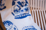 Eco Delft Throw's knitted texture with porcelain vase pattern in varying blue shades and grey.
