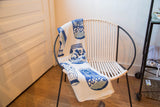 Eco Delft Throw blanket with dainty knit blue porcelain vase motifs.