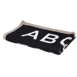 Eco-friendly ABC baby blanket, black with white letters, beige knitted trim, 30x40 inches.