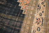 Antique Doroksh carpet detail: exposed warp on navy field, with blush floral patterns.