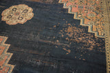 Antique Persian Doroksh carpet: visible wear to foundation, dark navy field, blush stepped spandrel.